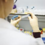 person holding test tubes