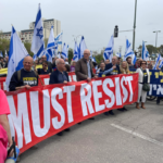 Israeli protestors holding a a "Must Resist" banner