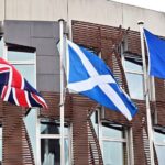 Scottish flag, alongside the UK and EU flags, at the Scottish parliament